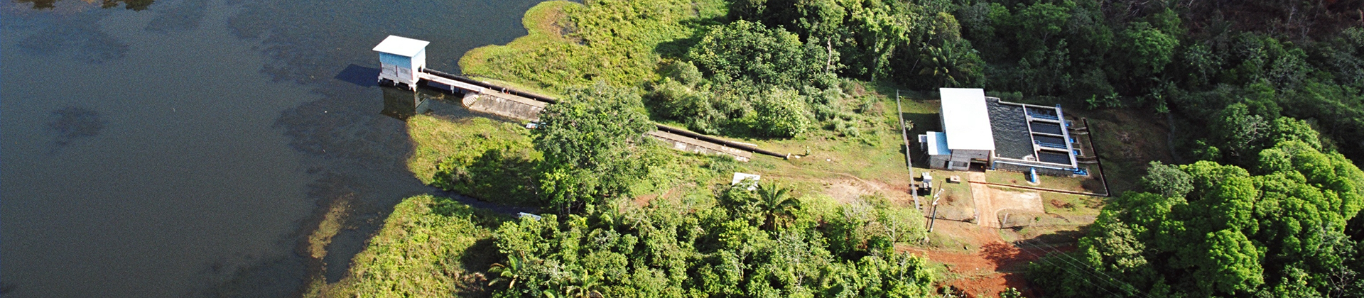Benefits of Decentralized Water and Wastewater Treatment Aerial view of a compact water treatment facility and intake near a reservoir